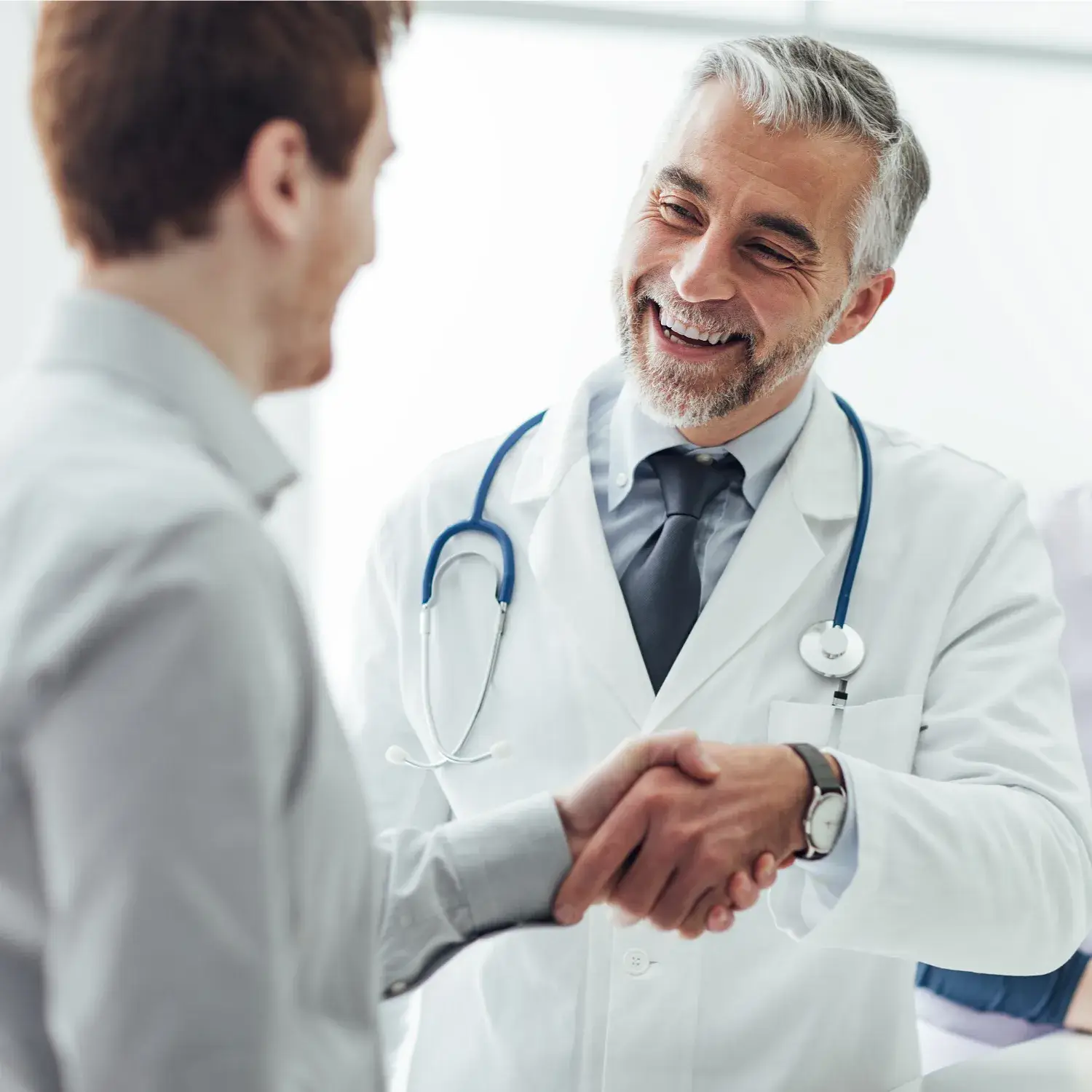 Doctor is shaking hand with a young man